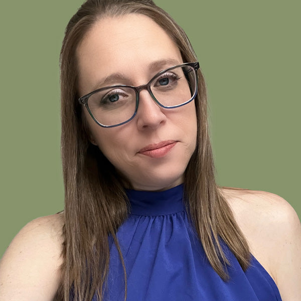 Photo of designer Michelle Elise wearing glasses and a blue top